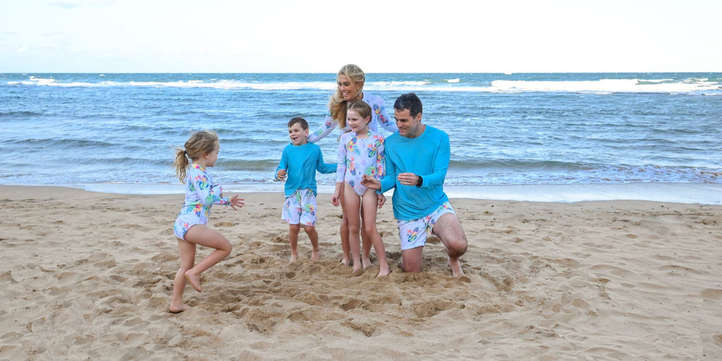 Family wearing matching sun protective swimwear on a beach in Australia